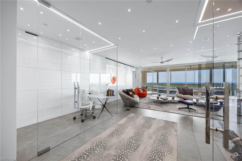 425 Dockside Drive, Unit 905 Naples, FL 34110 - Photo 9 of 50 a living room with lots of chairs and wood floor