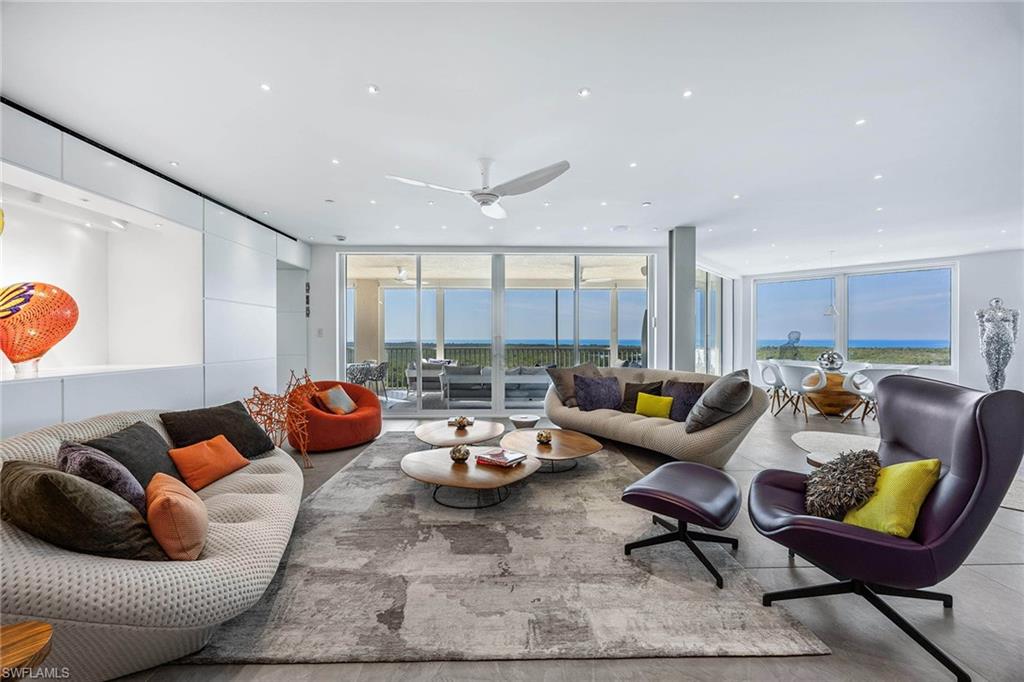 425 Dockside Drive, Unit 905 Naples, FL 34110 - Photo 10 of 50 a living room with furniture and a large window