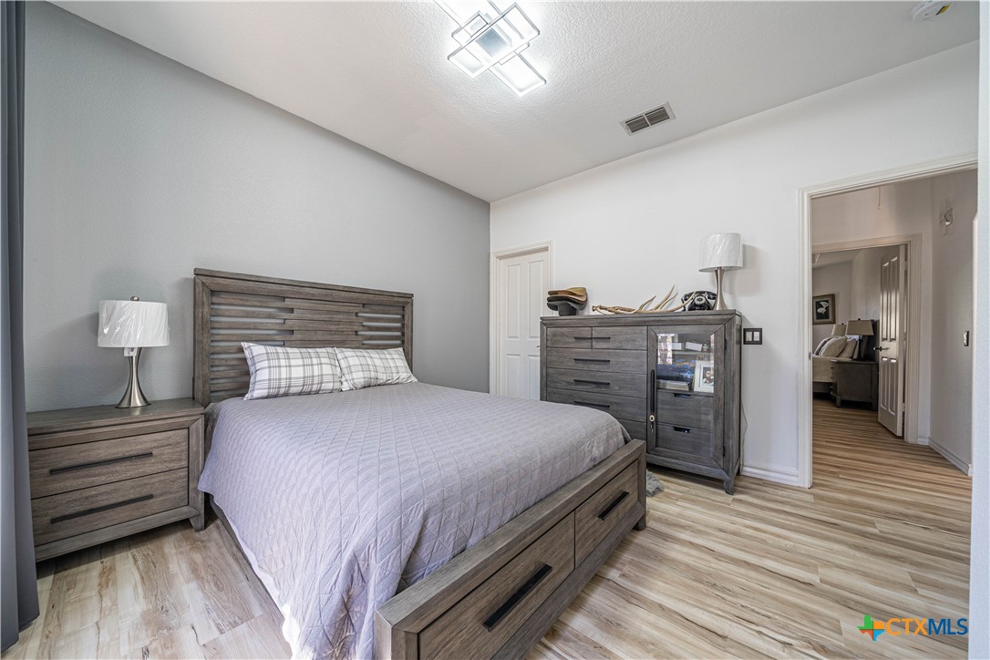 519 Long Meadow Spring Branch, TX 78070 - Photo 24 of 33 a bedroom with a bed and wooden floor