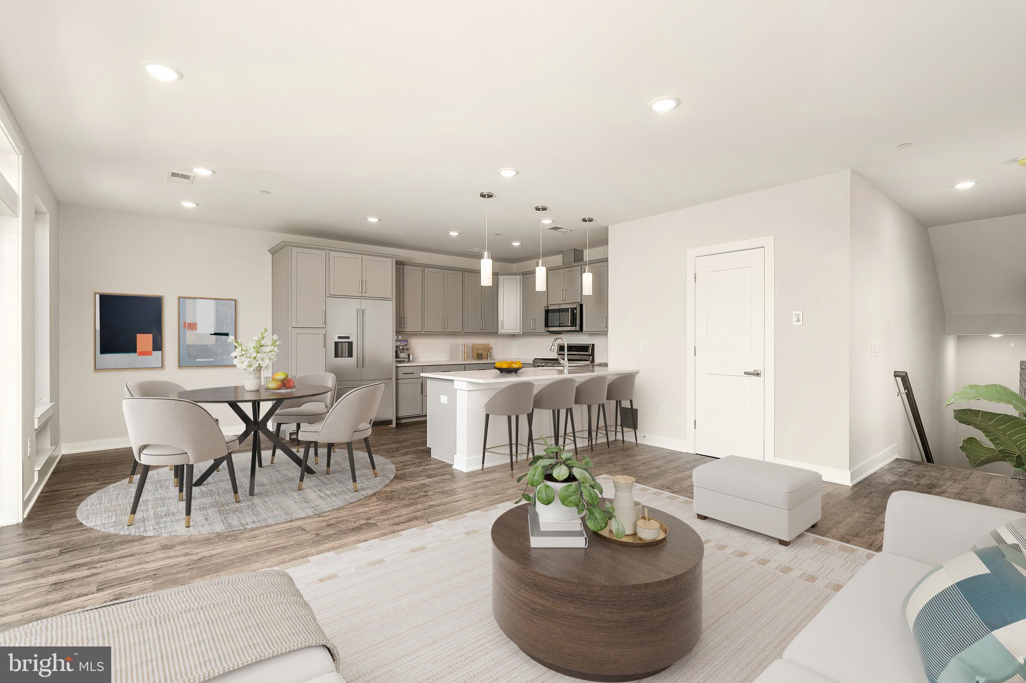 a living room with furniture and a dining table with kitchen view
