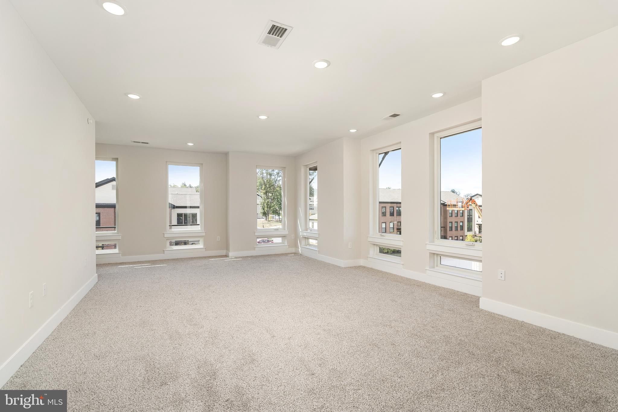 112 Village Drive Skillman, NJ 08558 - Photo 16 of 33 an empty room with windows and entrance to other room