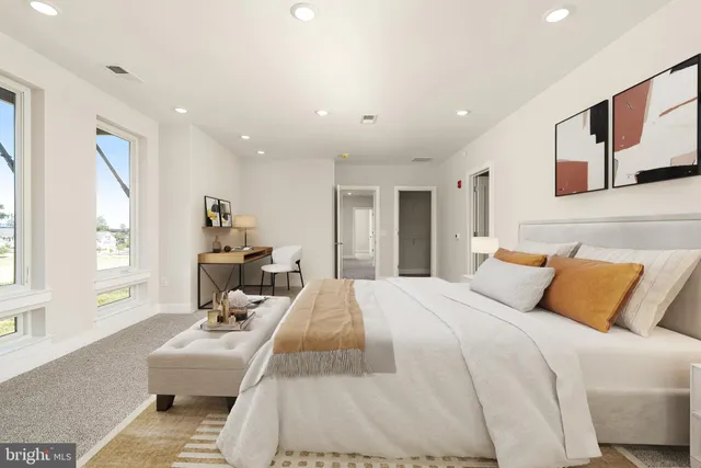 a bedroom with a large bed couch and a window