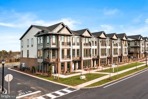 a view of a large building with a lawn chairs and plants