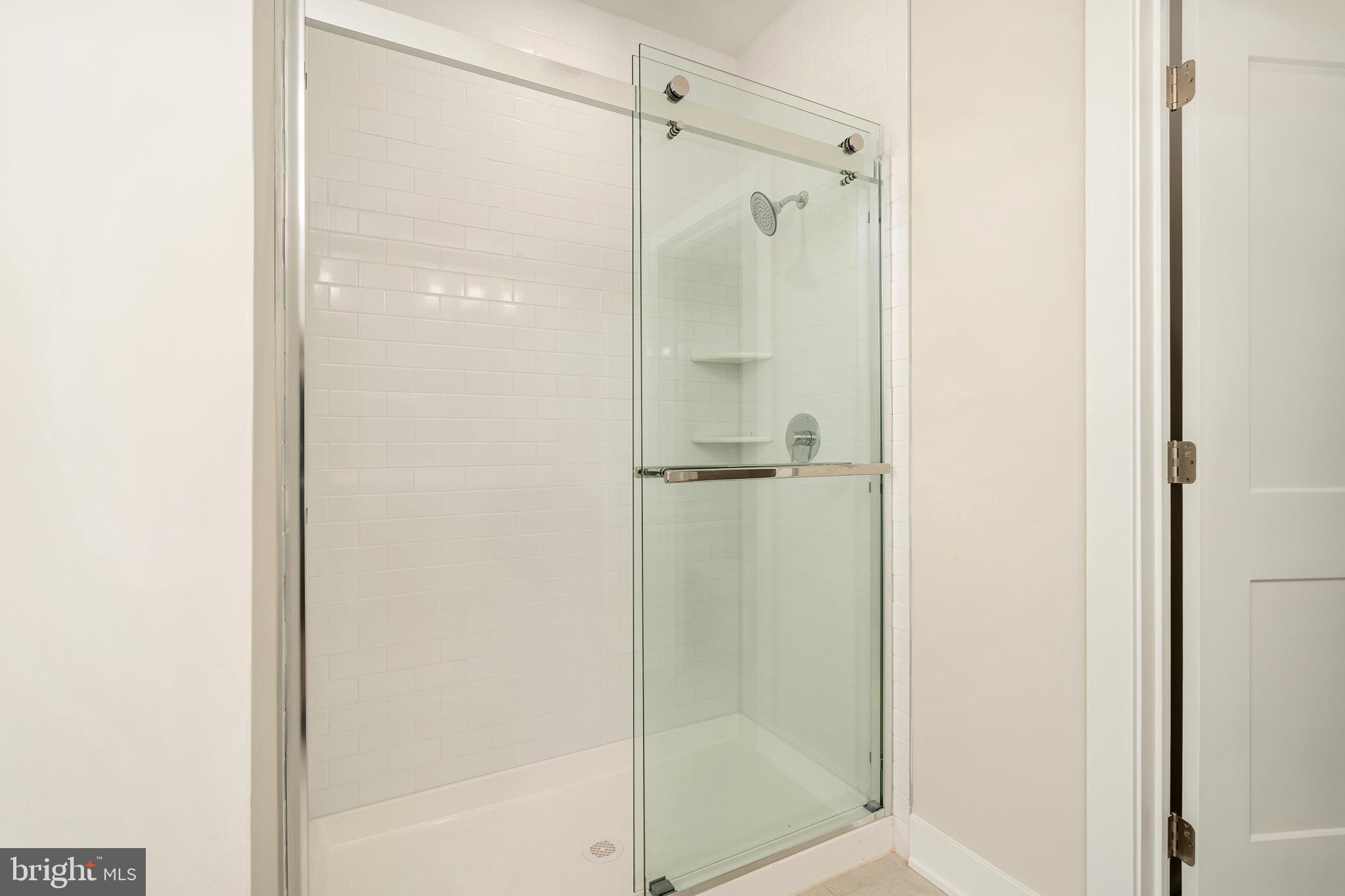 112 Village Drive Skillman, NJ 08558 - Photo 21 of 33 a bathroom with a glass shower door