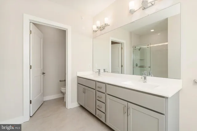a bathroom with a sink double vanity and a mirror
