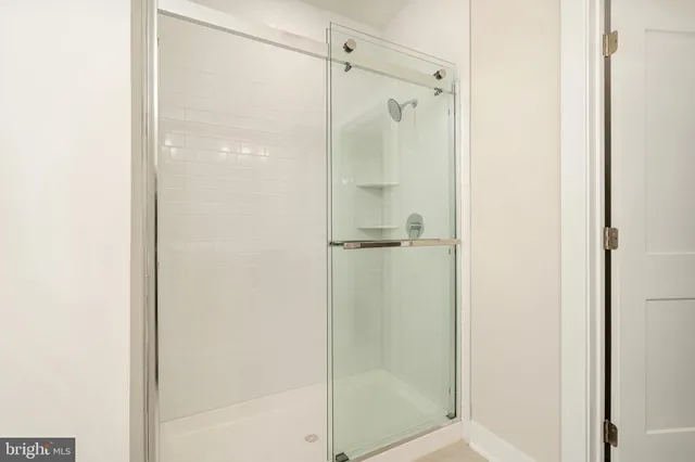 a bathroom with a glass shower door