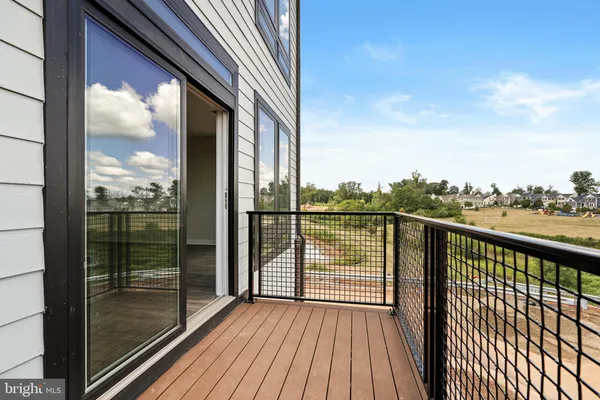 a view of a balcony with floor to ceiling window wooden floor with brick wall