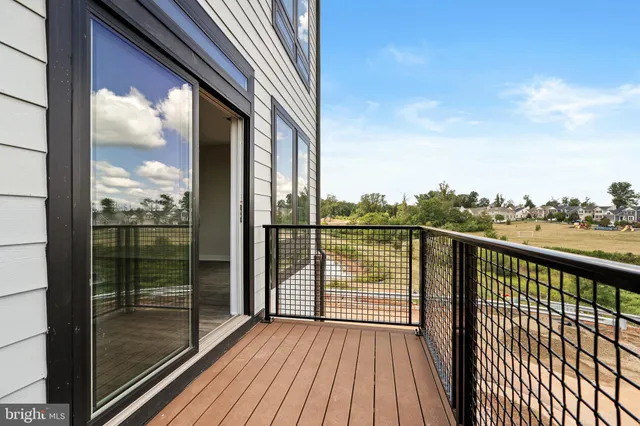 a view of a balcony with floor to ceiling window wooden floor with brick wall