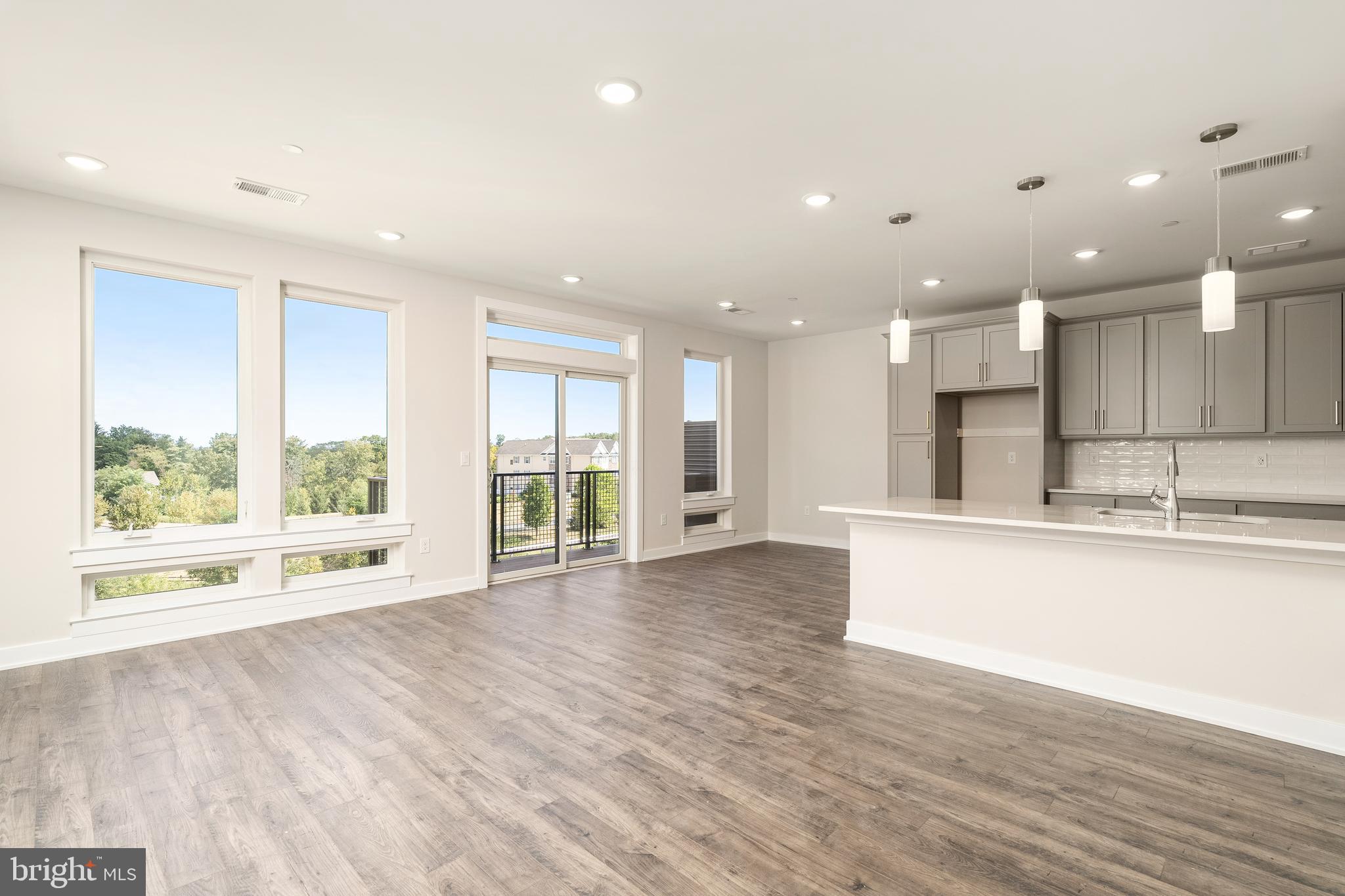 112 Village Drive Skillman, NJ 08558 - Photo 6 of 33 a view of kitchen with kitchen island wooden floor and living room