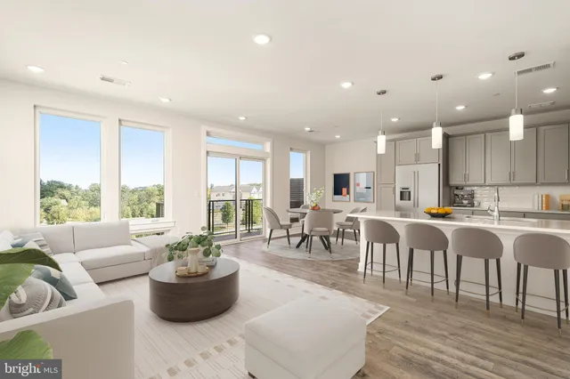 a living room with lots of furniture and a large window