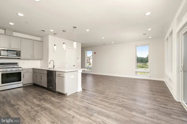 a view of kitchen with wooden floor and electronic appliances