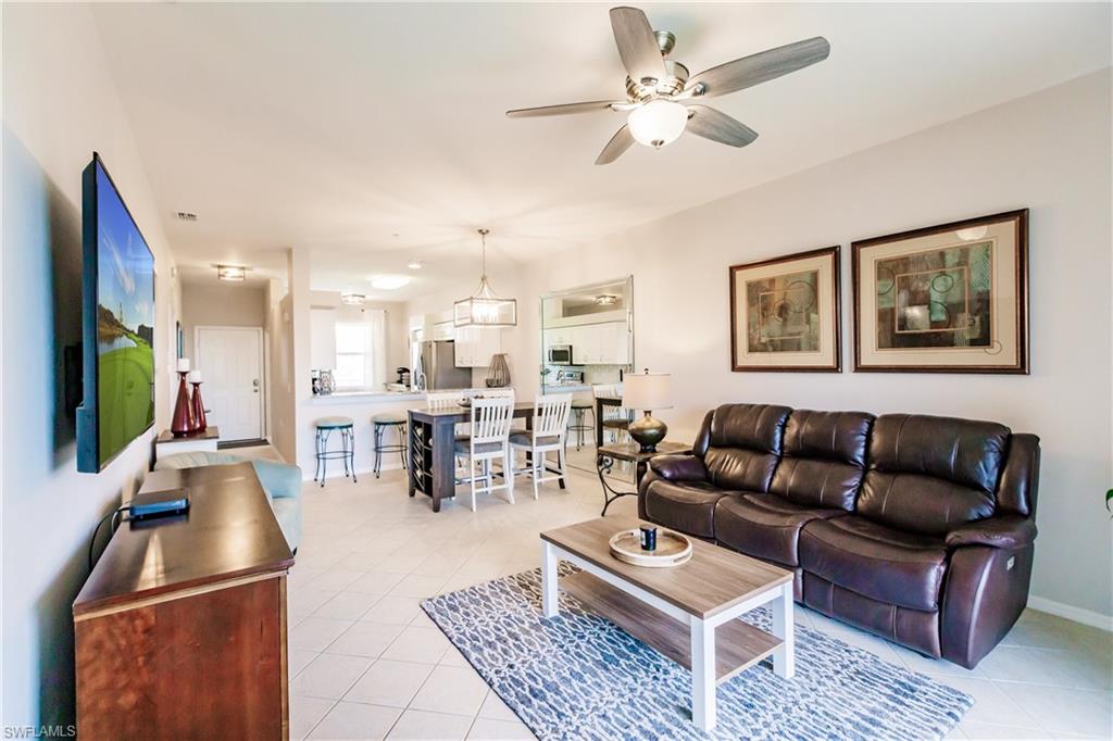 3820 Sawgrass Way, Unit 3043 Naples, FL 34112 - Photo 12 of 44 a living room with furniture and a flat screen tv