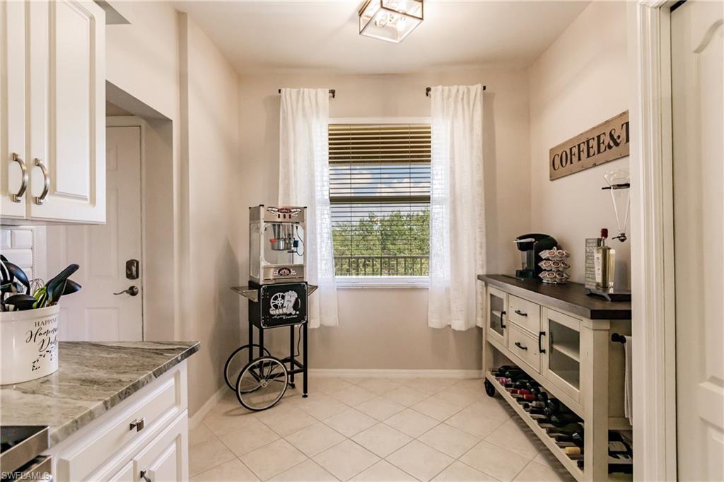 3820 Sawgrass Way, Unit 3043 Naples, FL 34112 - Photo 18 of 44 a kitchen with stainless steel appliances a sink a stove and a window