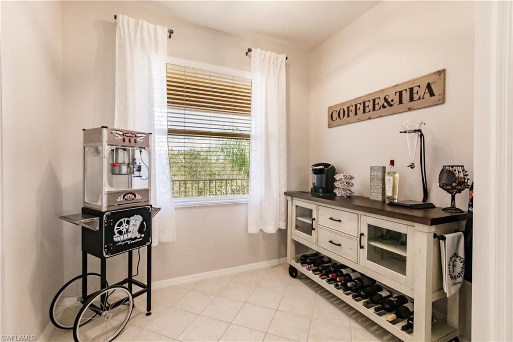 3820 Sawgrass Way, Unit 3043 Naples, FL 34112 - Photo 20 of 44 a kitchen with stainless steel appliances a stove a sink and cabinets