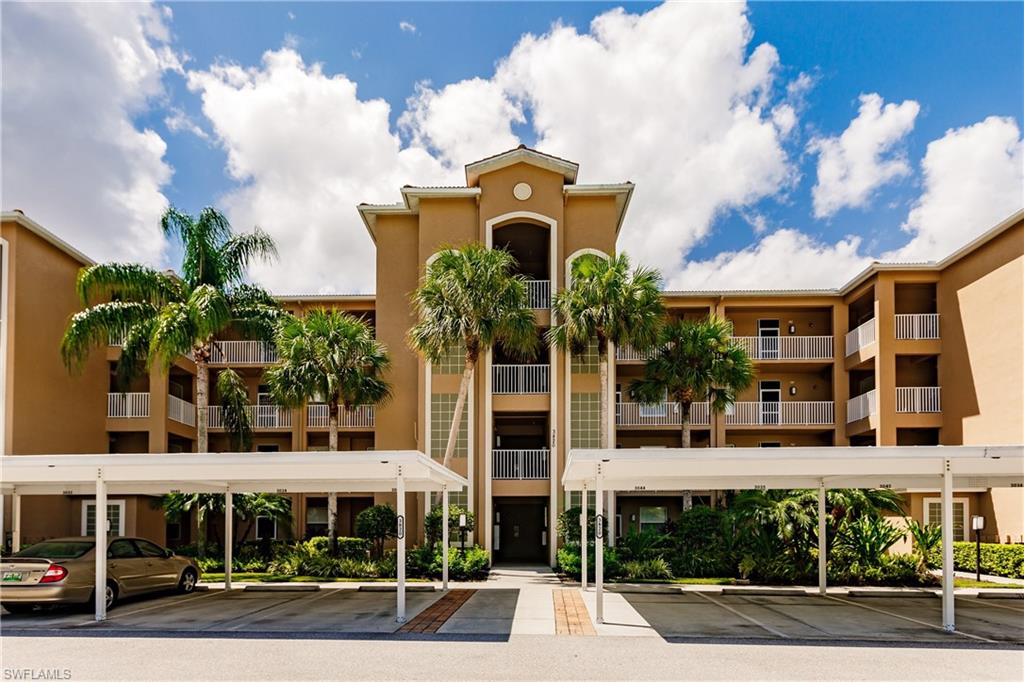 3820 Sawgrass Way, Unit 3043 Naples, FL 34112 - Photo 2 of 44 front view of a building with a street