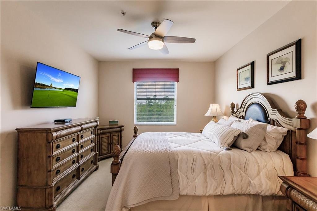 3820 Sawgrass Way, Unit 3043 Naples, FL 34112 - Photo 22 of 44 a bedroom with a bed and a flat screen tv