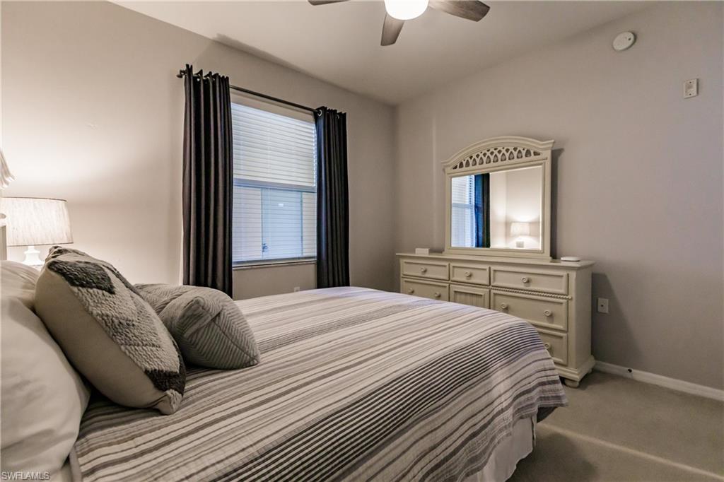 3820 Sawgrass Way, Unit 3043 Naples, FL 34112 - Photo 26 of 44 a bedroom with a bed and a window