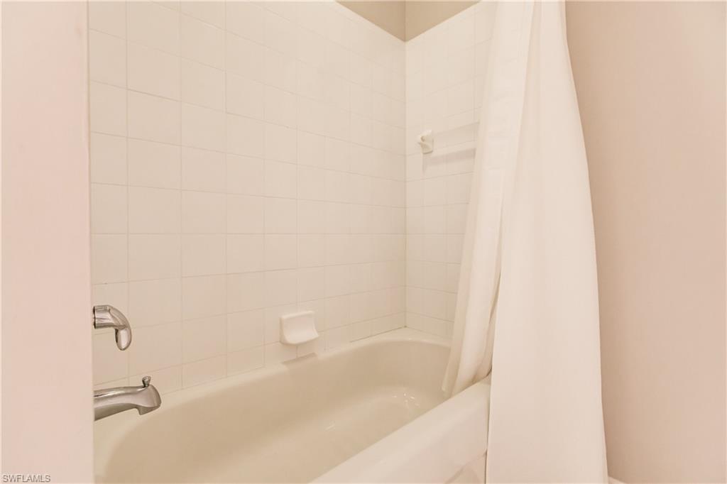 3820 Sawgrass Way, Unit 3043 Naples, FL 34112 - Photo 30 of 44 a bathroom with a bathtub