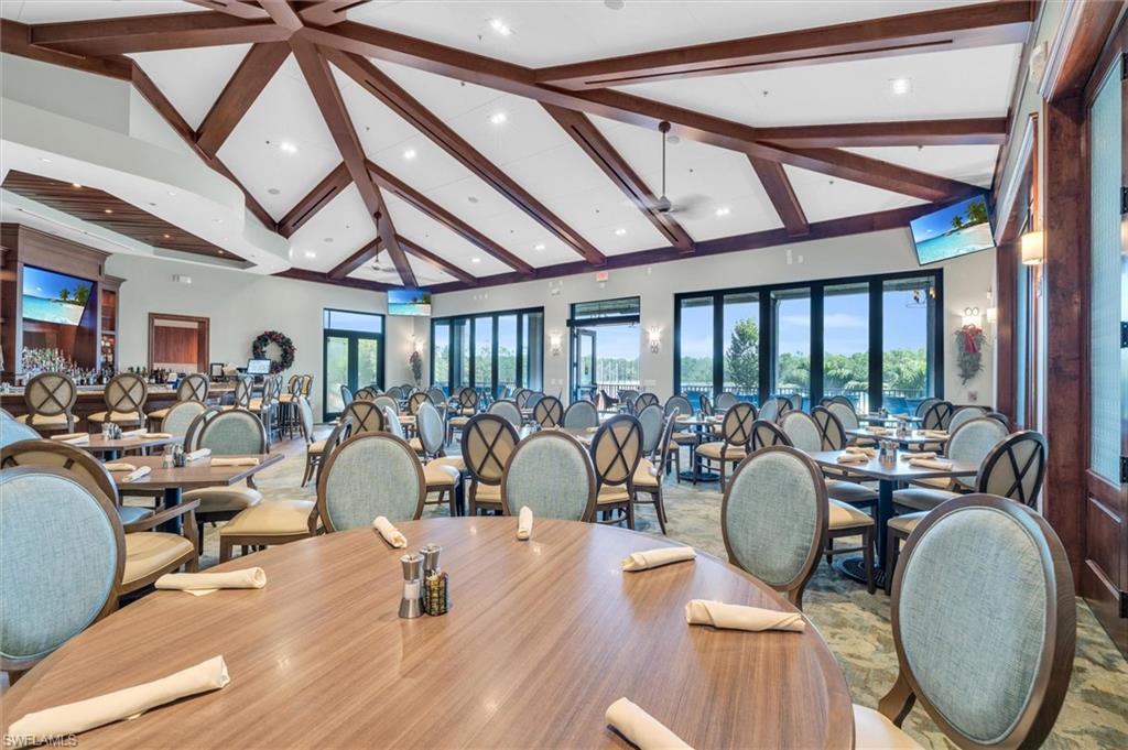 3820 Sawgrass Way, Unit 3043 Naples, FL 34112 - Photo 35 of 44 a living room with furniture a fireplace and a chandelier