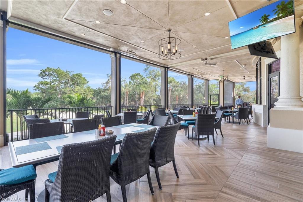 3820 Sawgrass Way, Unit 3043 Naples, FL 34112 - Photo 36 of 44 a view of a dining room with furniture window and outside view