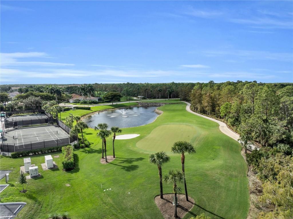 3820 Sawgrass Way, Unit 3043 Naples, FL 34112 - Photo 41 of 44 a view of a swimming pool with a yard and mountain view