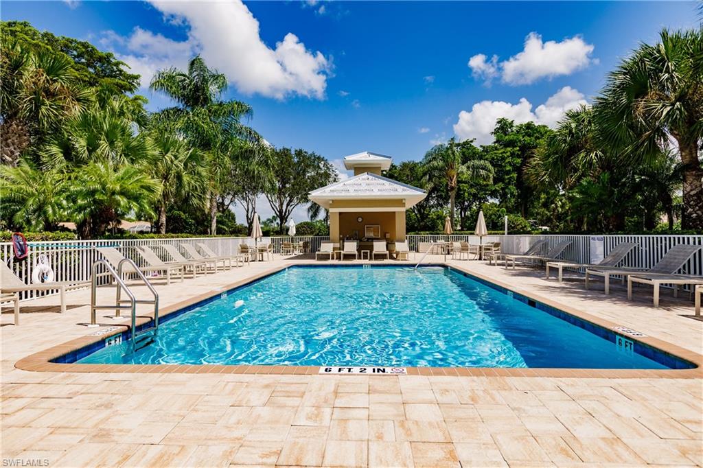 3820 Sawgrass Way, Unit 3043 Naples, FL 34112 - Photo 7 of 44 a view of a swimming pool with a patio
