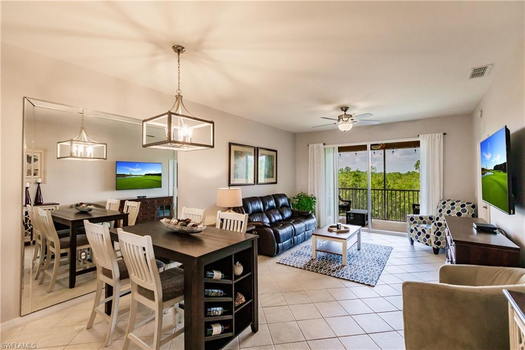 3820 Sawgrass Way, Unit 3043 Naples, FL 34112 - Photo 9 of 44 a living room with furniture a floor to ceiling window and a flat screen tv