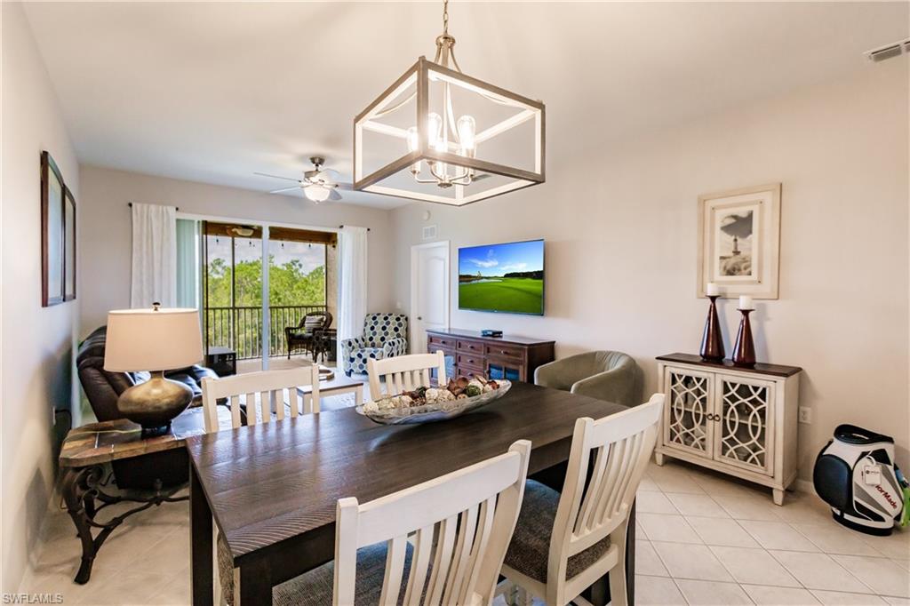 3820 Sawgrass Way, Unit 3043 Naples, FL 34112 - Photo 10 of 44 a view of a dining room with furniture window and outside view