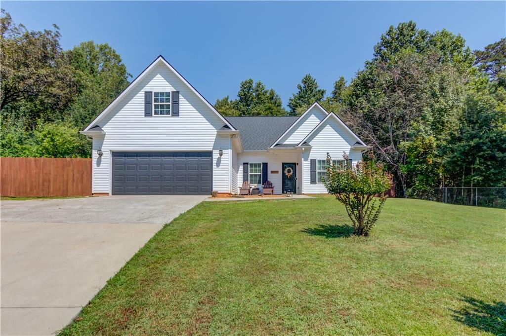 4990 Price Road Gainesville, GA 30506 - Photo 1 of 1 a view of backyard of house with wooden fence and trees