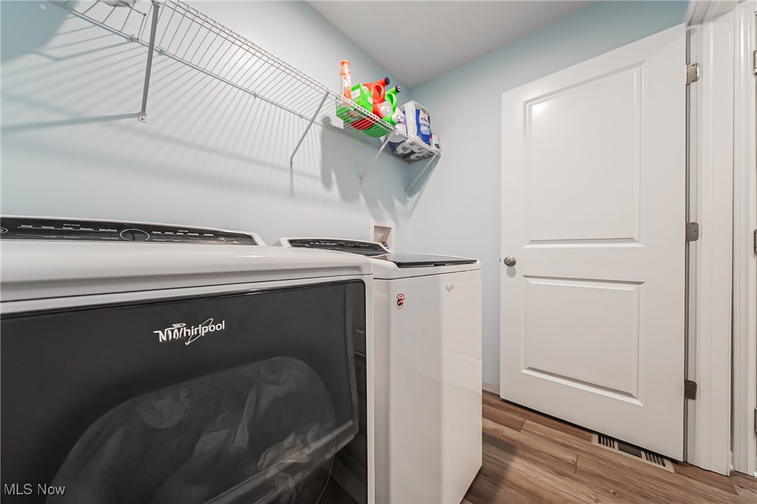 6105 Dunham Road Maple Heights, OH 44137 - Photo 27 of 38 Washroom featuring washer and dryer and wood finished floors