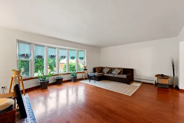 a dining room with furniture and wooden floor