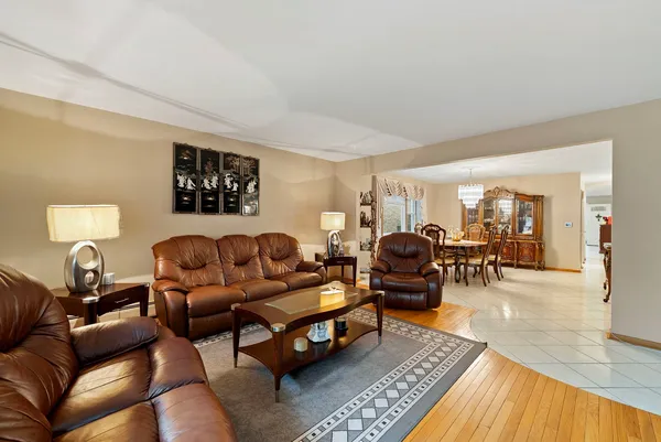 a living room with furniture a flat screen tv and a large window
