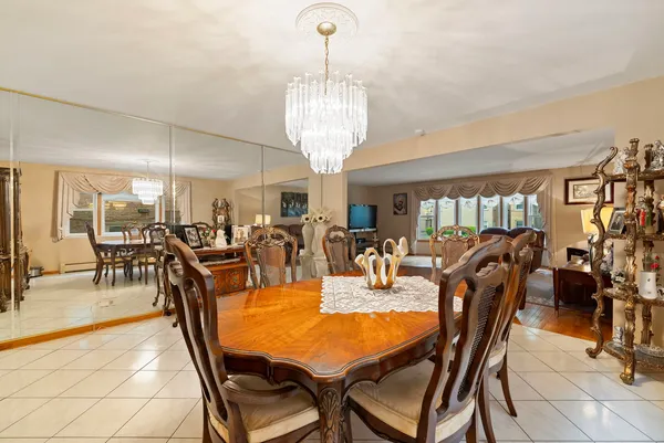 a kitchen with stainless steel appliances granite countertop a refrigerator a sink dishwasher a stove with white cabinets and wooden floor