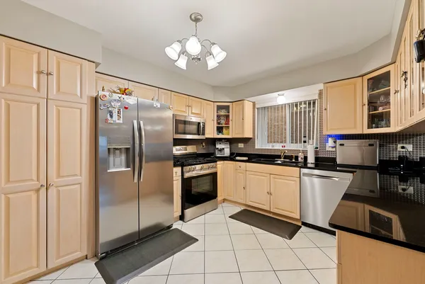 a kitchen with cabinets and chairs