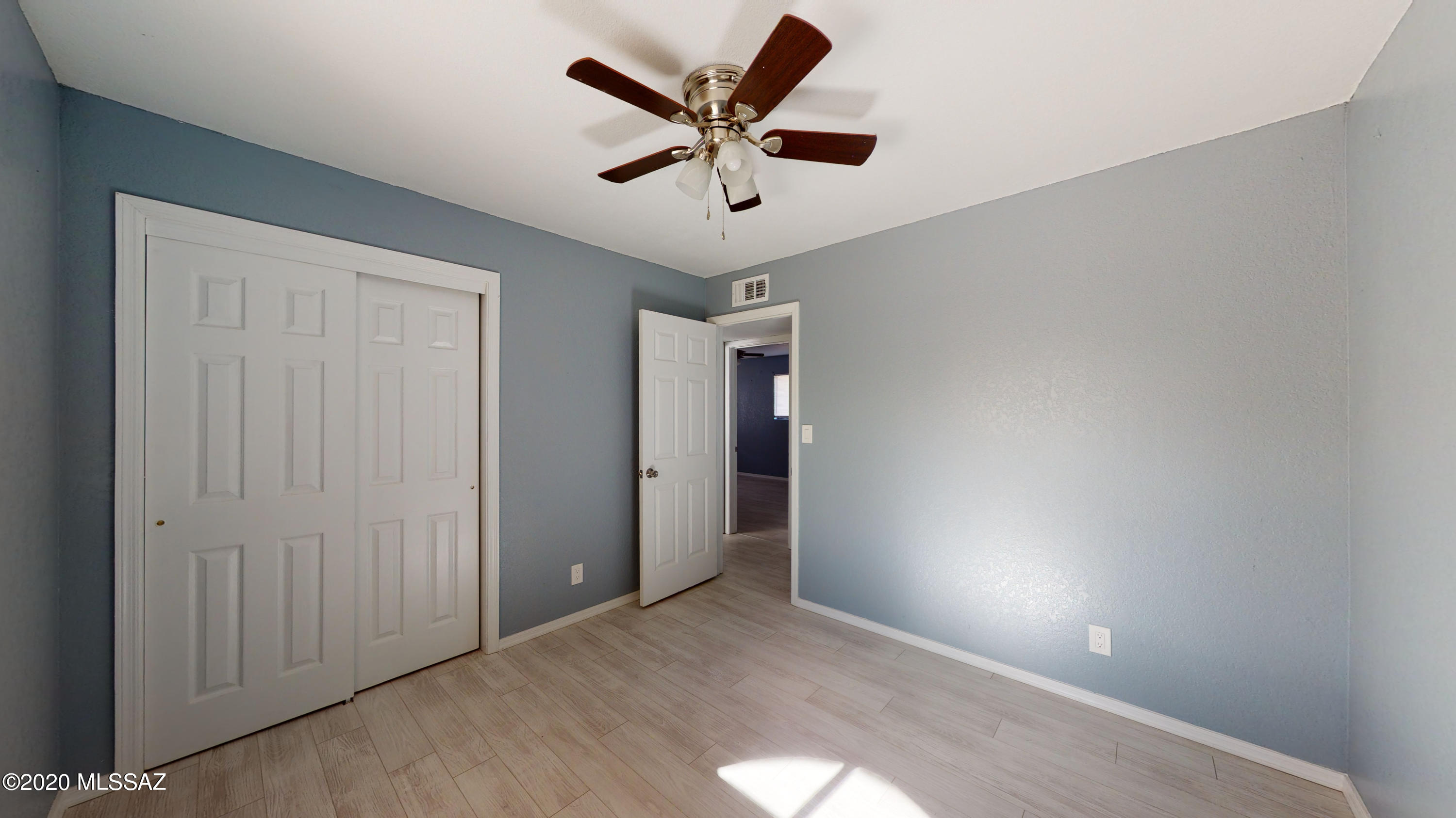 1034 Zorrita Court, Unit CORTE Rio Rico, AZ 85648 - Photo 10 of 16 an empty room with closet and a ceiling fan