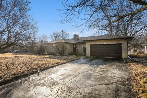 a view of a house with a yard and garage