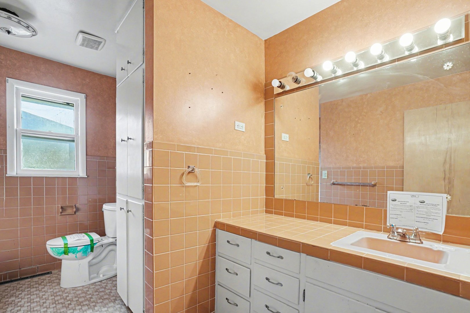 1124 West Hawkins Street Kankakee, IL 60901 - Photo 11 of 22 a bathroom with a granite countertop sink a toilet and a mirror