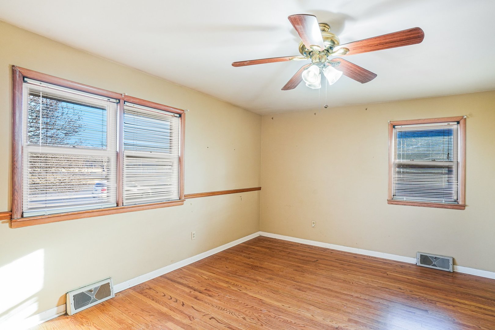 1124 West Hawkins Street Kankakee, IL 60901 - Photo 12 of 22 a view of an empty room with wooden floor and a window