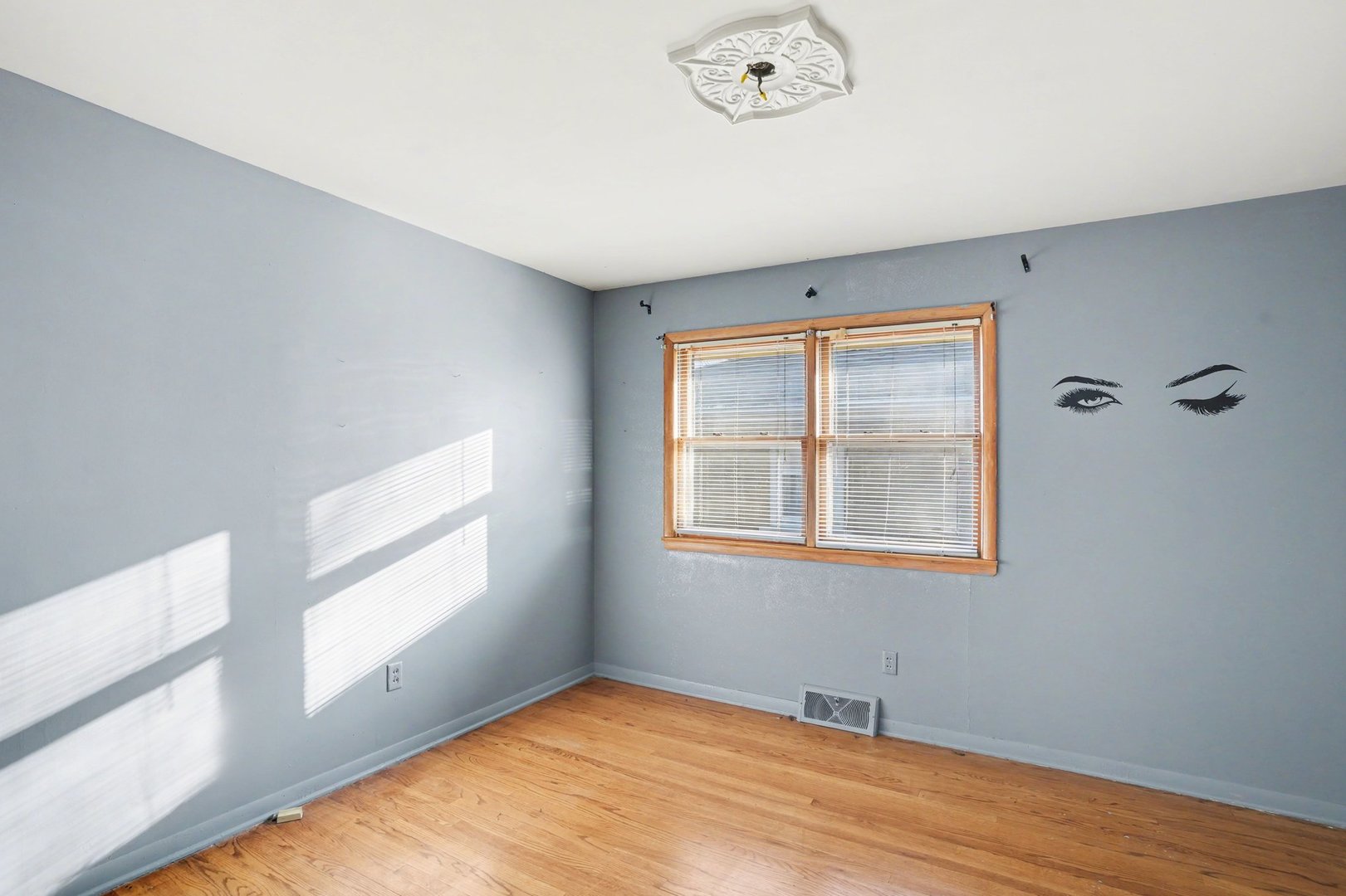 1124 West Hawkins Street Kankakee, IL 60901 - Photo 14 of 22 an empty room with wooden floor and windows