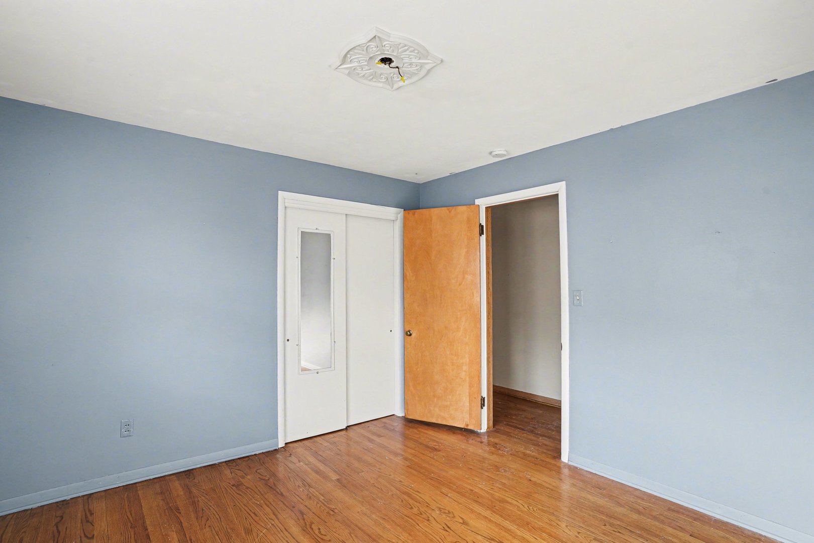 1124 West Hawkins Street Kankakee, IL 60901 - Photo 15 of 22 a view of an empty room with wooden floor and a window