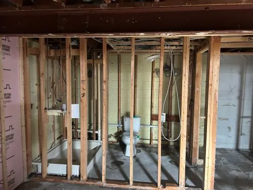 a view of a hallway with wooden floor and living room