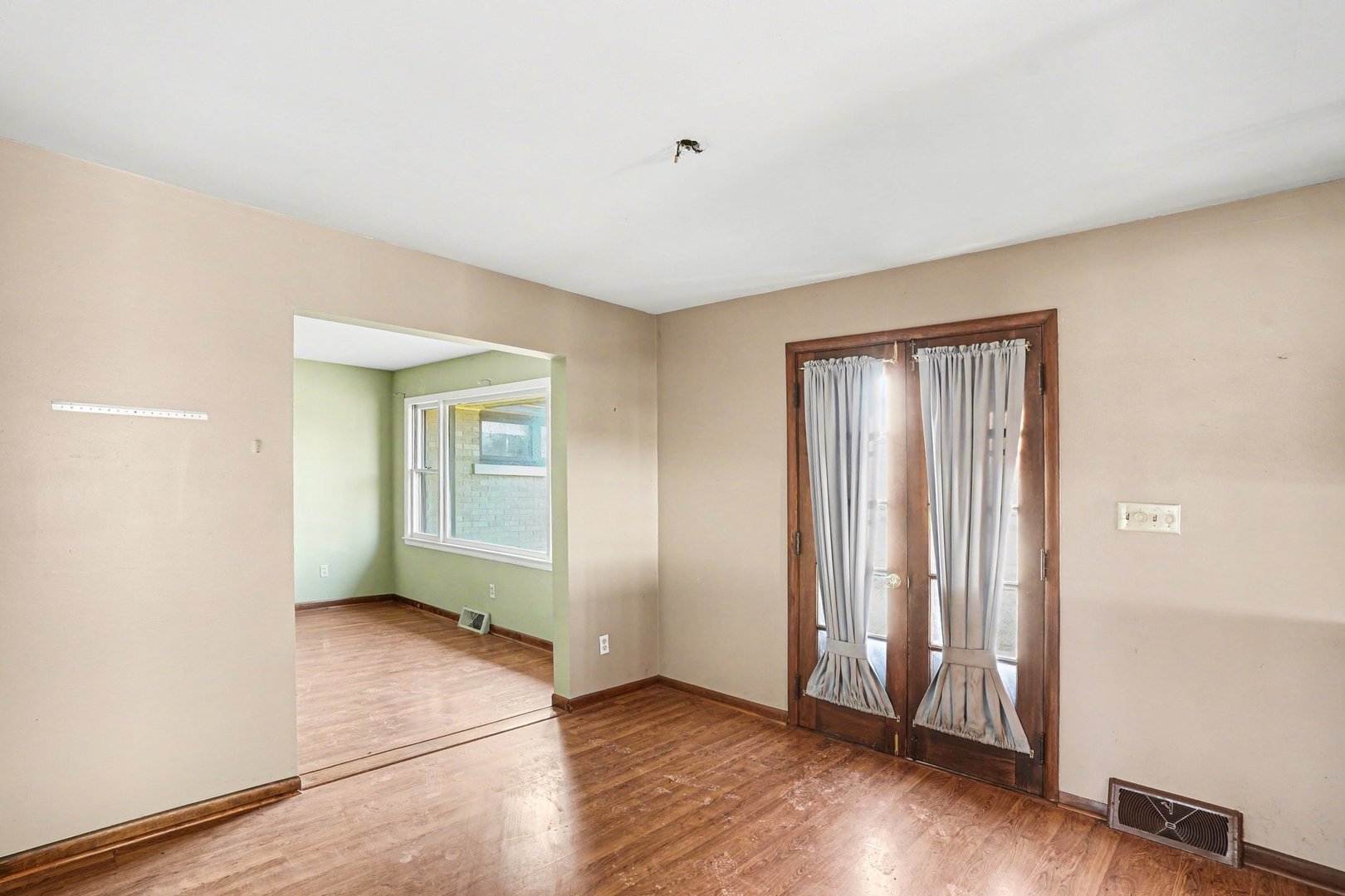 1124 West Hawkins Street Kankakee, IL 60901 - Photo 5 of 22 an empty room with wooden floor and windows