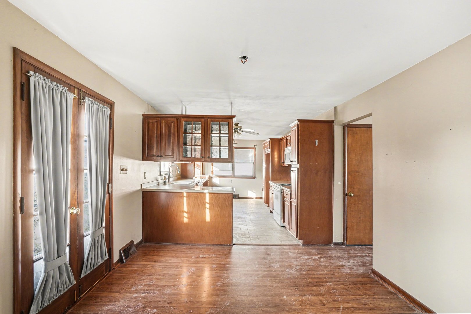 1124 West Hawkins Street Kankakee, IL 60901 - Photo 6 of 22 a view of a kitchen with kitchen island wooden floors and stainless steel appliances