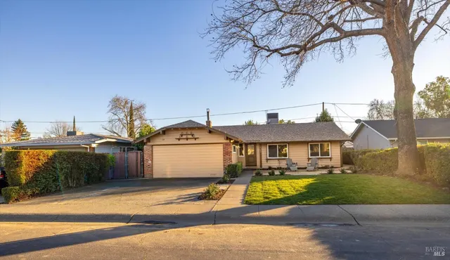 a view of a swimming pool with a lawn chairs under an umbrella