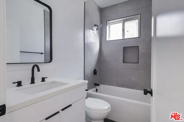 a bathroom with a toilet a sink and a bathtub