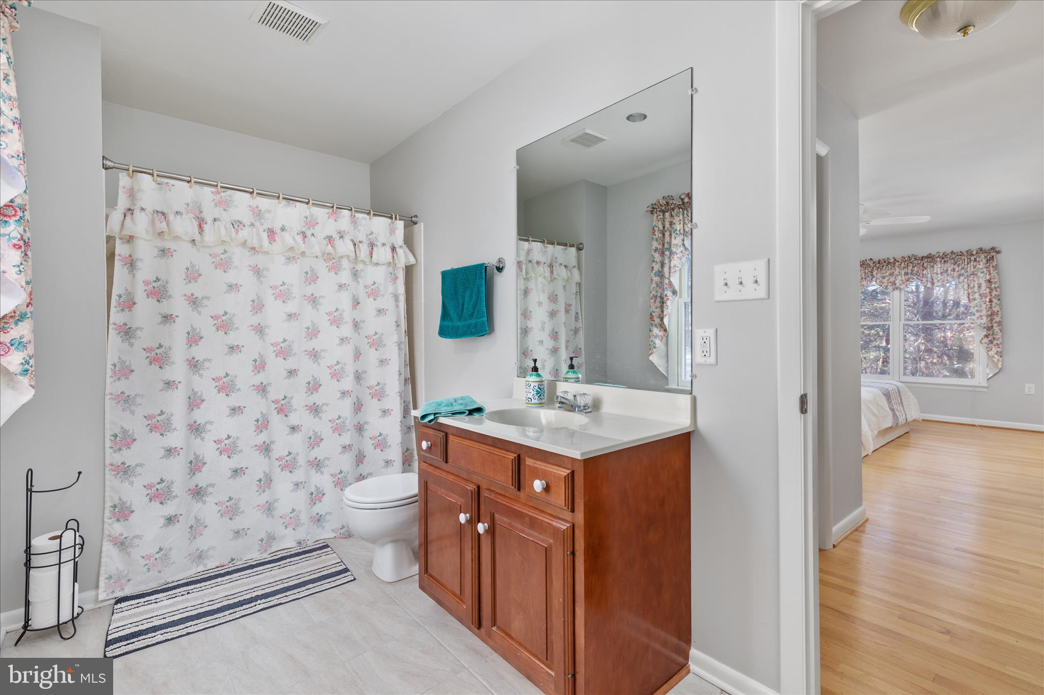 7239 Supinlick Ridge Road Mount Jackson, VA 22842 - Photo 20 of 39 a spacious bathroom with a granite countertop sink a toilet a mirror and shower curtain
