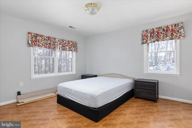 a view of a room with wooden floor