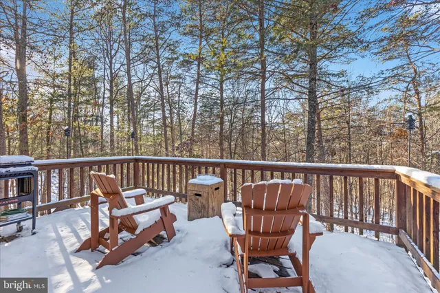 a view of a house with a yard covered in snow