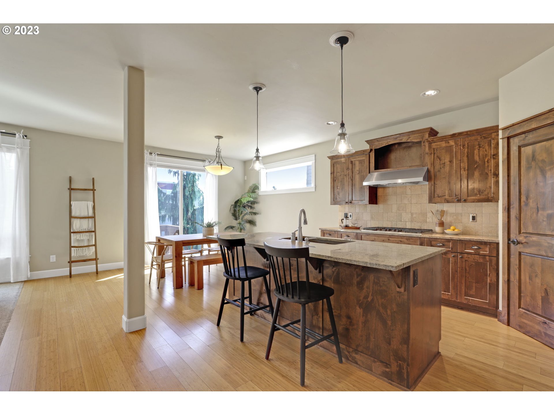 9806 Northwest Wayne Lane Portland, OR 97229 - Photo 6 of 21 a kitchen with stainless steel appliances granite countertop a sink a stove a refrigerator and island with wooden floor