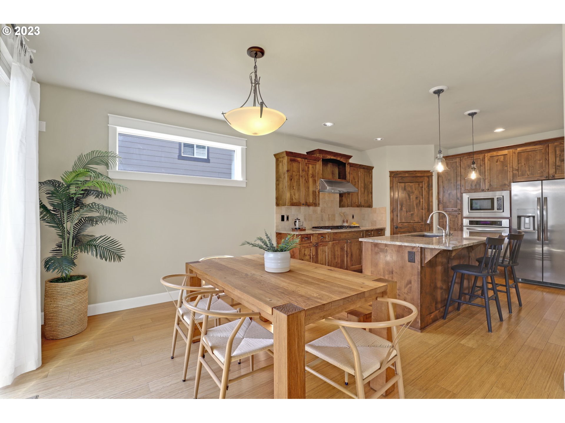 9806 Northwest Wayne Lane Portland, OR 97229 - Photo 10 of 21 a kitchen with a table and chairs
